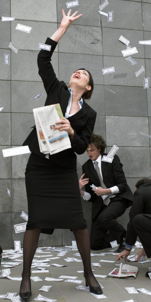 Business people on street catching falling money